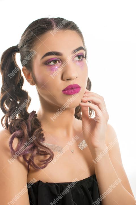 A striking portrait of a young woman with dramatic makeup
