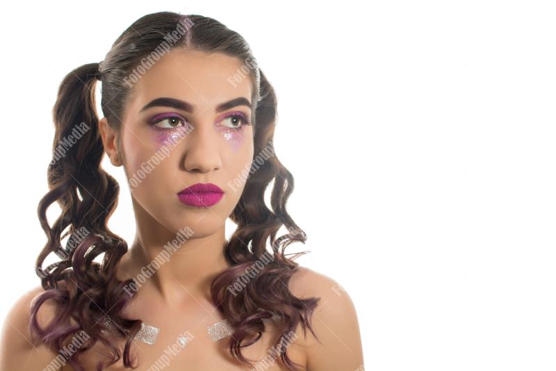 A striking portrait of a young woman with dramatic makeup