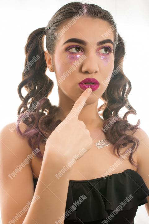 A striking portrait of a young woman with dramatic makeup