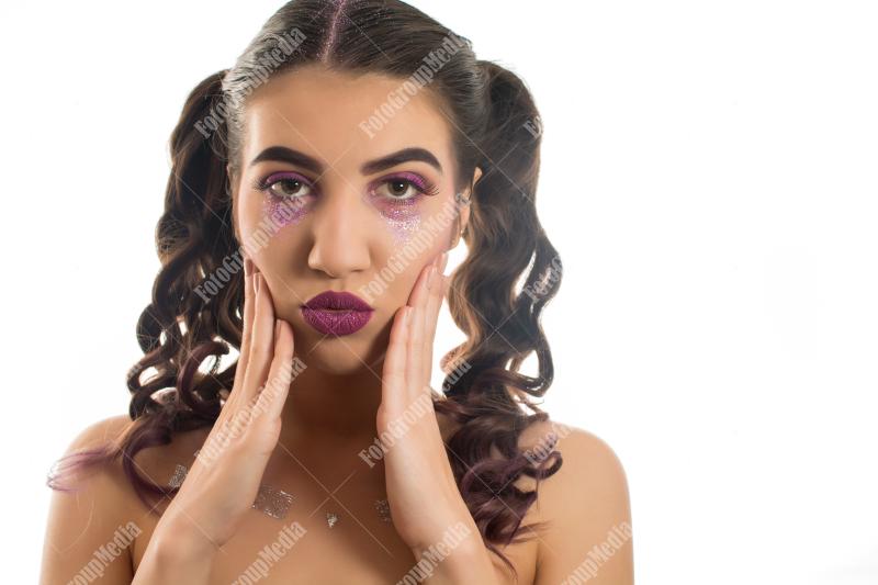 A young woman flaunts a playful mix of beauty and edginess