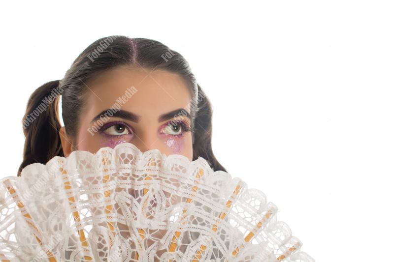 Young girl with artistic make up and lace fan