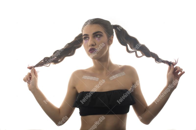 Confident young woman styled with playful pigtails