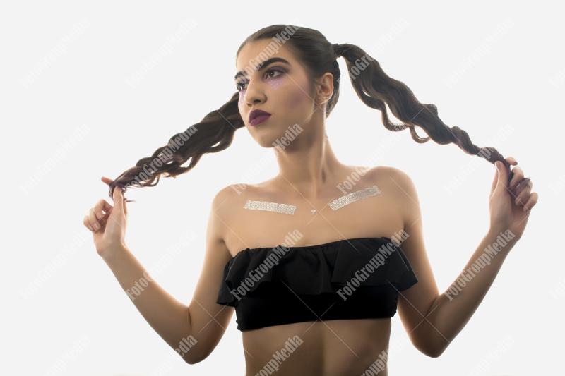 Confident young woman styled with playful pigtails
