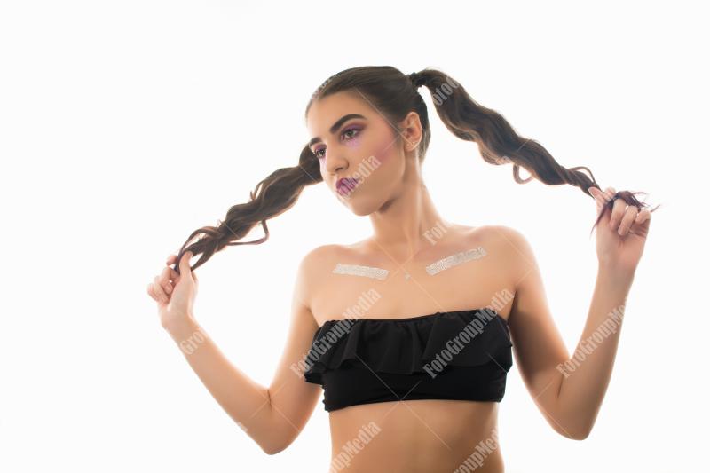 Confident young woman styled with playful pigtails