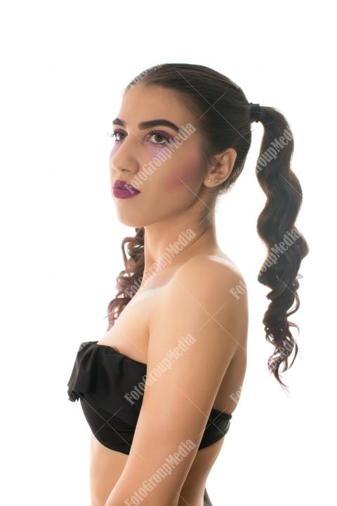 A striking portrait of a young woman with dramatic makeup,