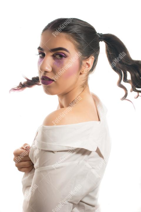 A whimsical portrait of a young woman with playful pigtails