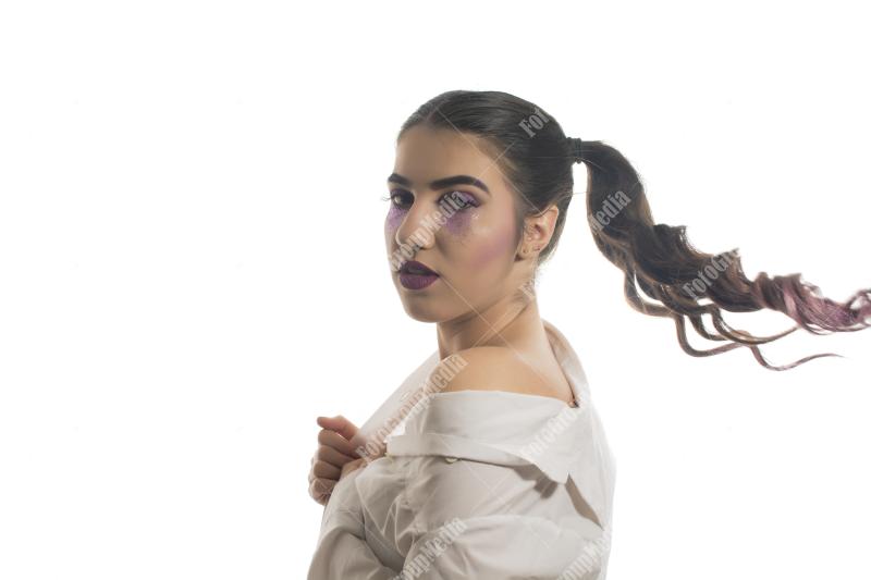 A whimsical portrait of a young woman with playful pigtails