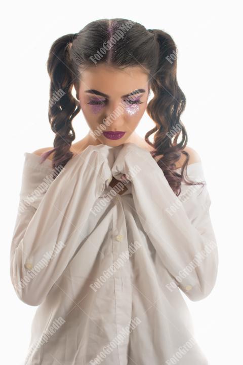 Young woman with artistic make up on white background