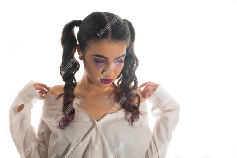 Young woman with artistic make up on white background