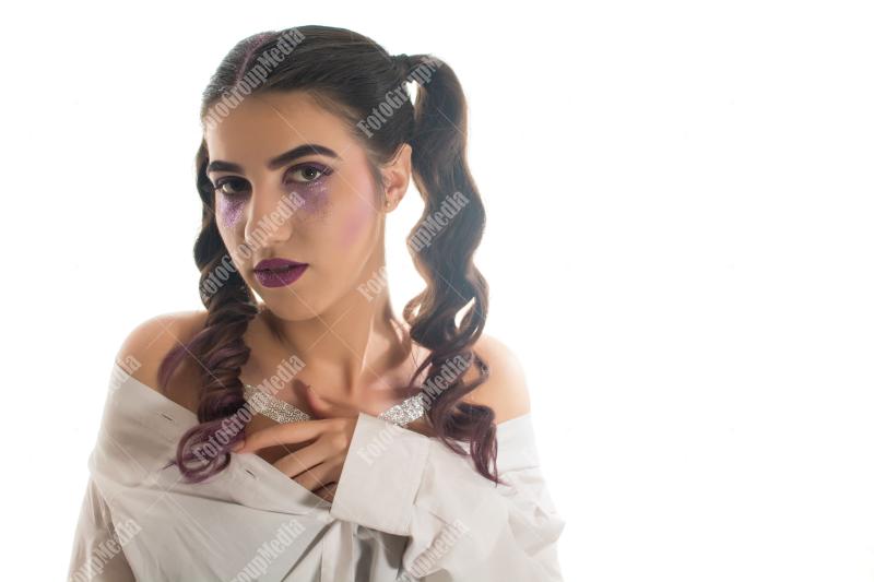 Young woman with artistic make up on white background