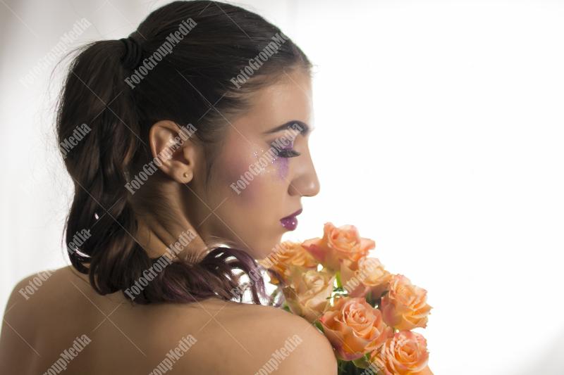 Young woman with yellow roses
