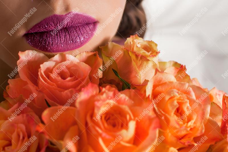 Close up of yellow roses and purple lips