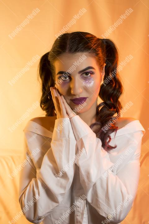 A young woman flaunts a playful mix of beauty and edginess