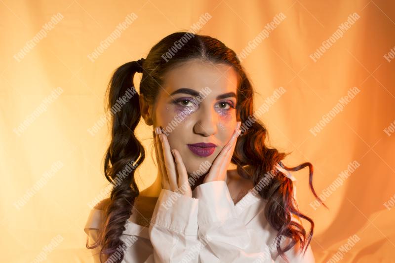 A young woman flaunts a playful mix of beauty and edginess