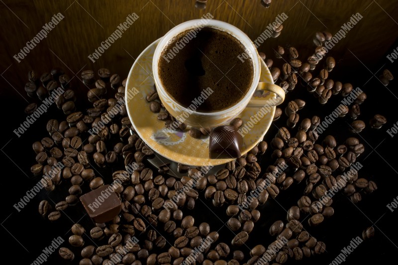 Coffee beans and a hot cup of coffee