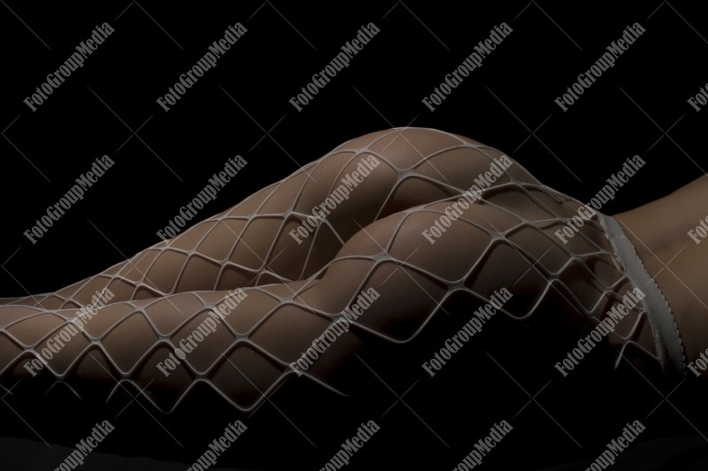 Sensual woman dressed in fishnet pantyhose