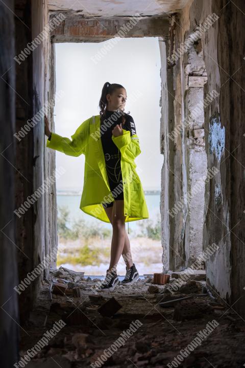 Neon jacket and gym perfect outfit for a derelic building