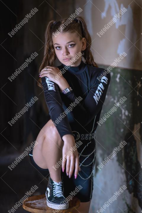 Young girl posing wearing bodysuit in an old building