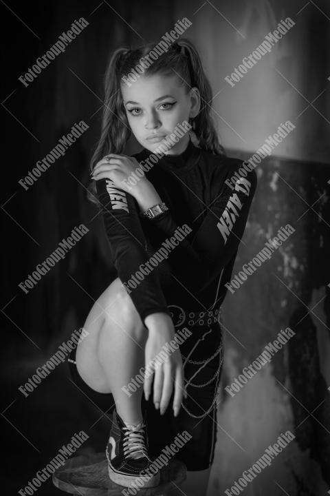 Young girl posing wearing bodysuit in an old building
