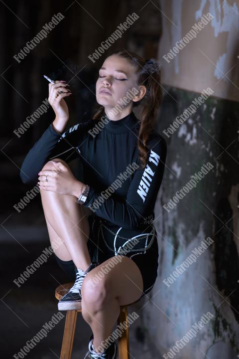 Young girl posing wearing bodysuit in an old building