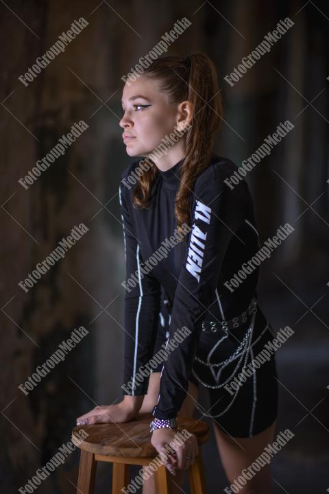 Young girl posing wearing bodysuit in an old building
