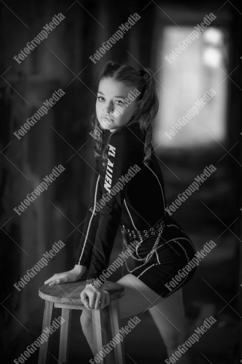 Young girl posing wearing bodysuit in an old building