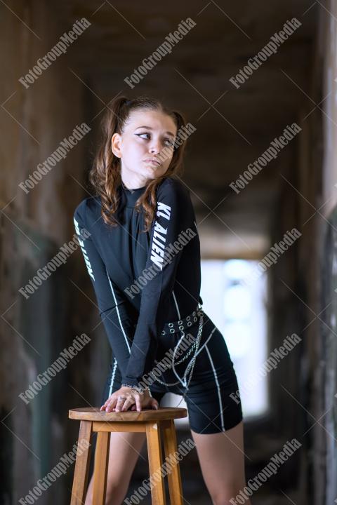 Young girl posing wearing bodysuit in an old building