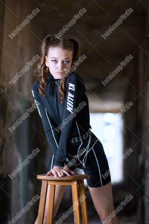 Young girl posing wearing bodysuit in an old building