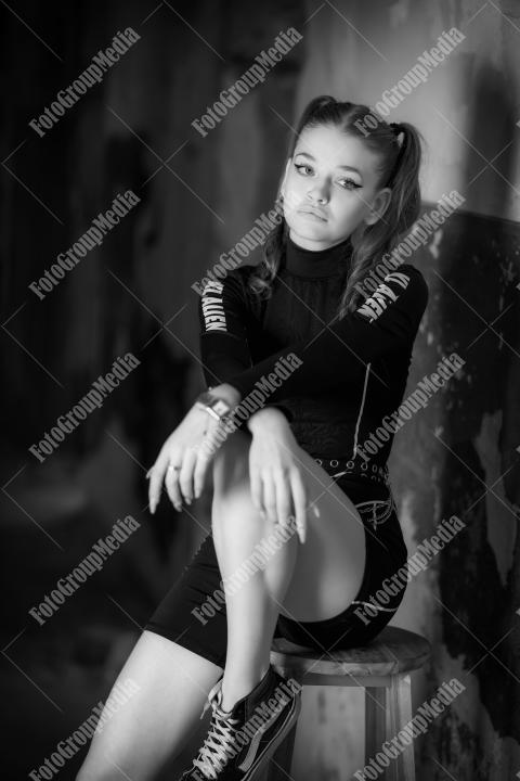 Young girl posing wearing bodysuit in an old building