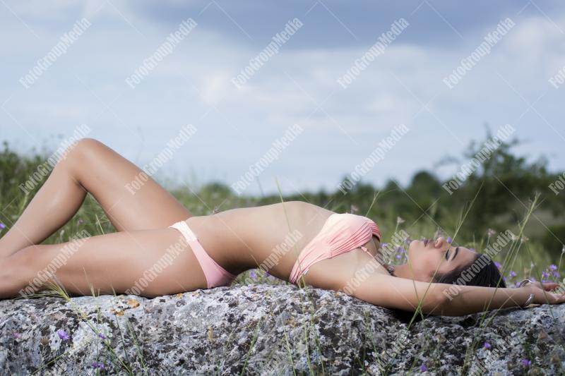 Young girl in pink lingerie posing outdoor