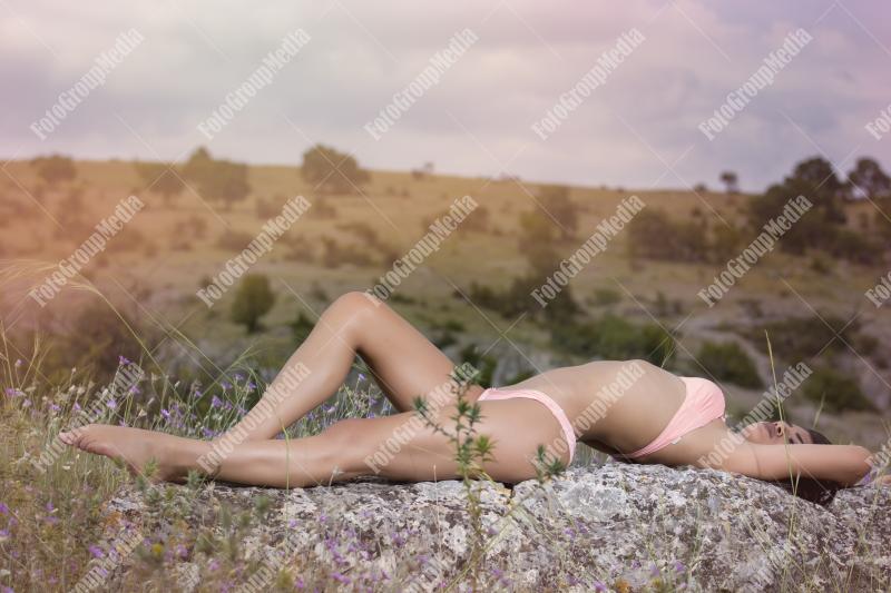 Young girl in pink lingerie posing outdoor