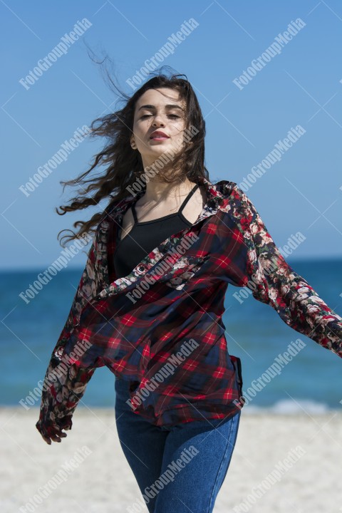 Happy woman enjoying a summer day at the beach