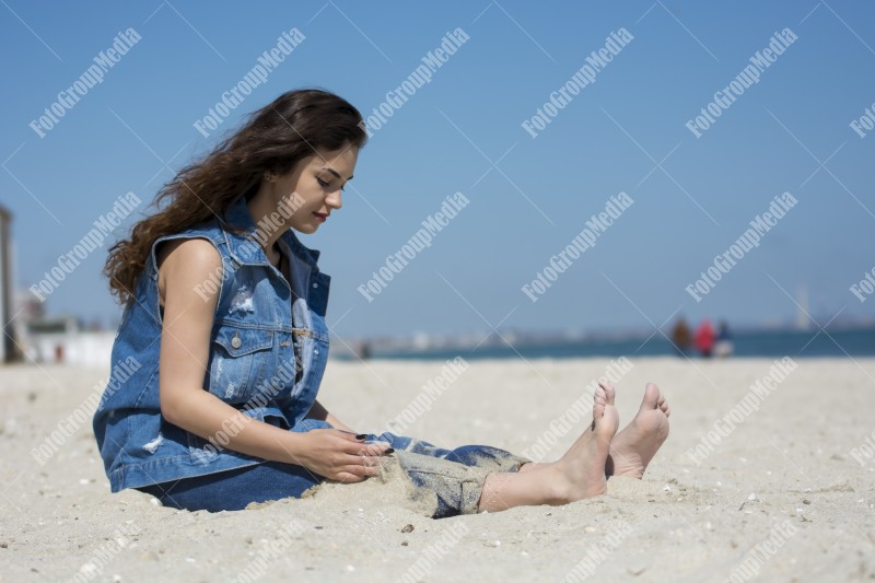 Happy woman enjoying a summer day at the beach