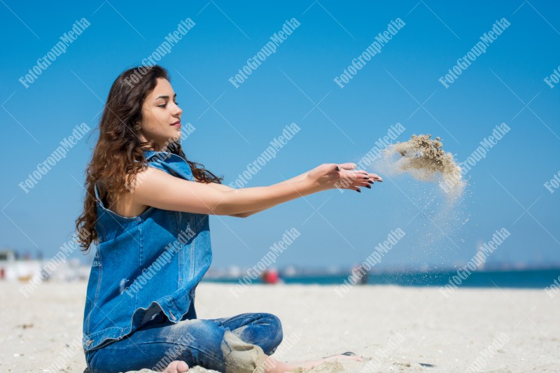 Playing with sand on beach, summer day