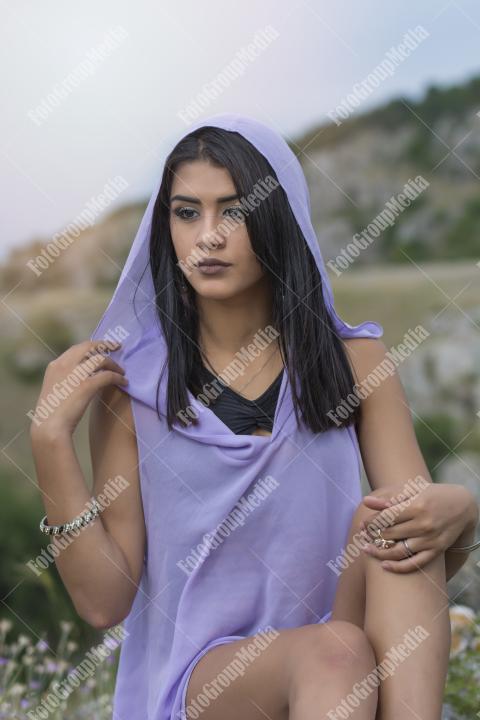 Young girl wearing purple outfit posing outdoor