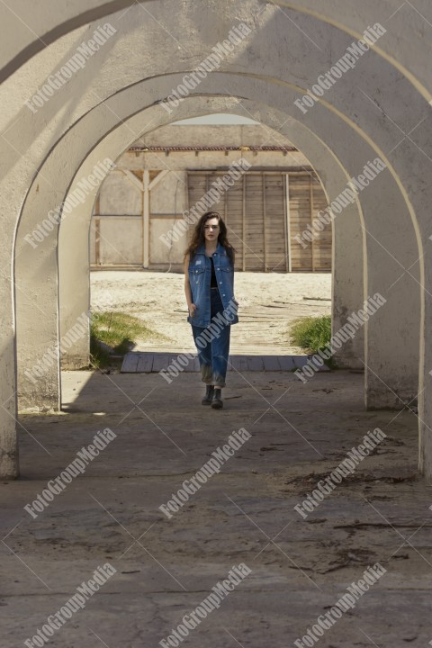 Young woman dressed in denim posing for camera
