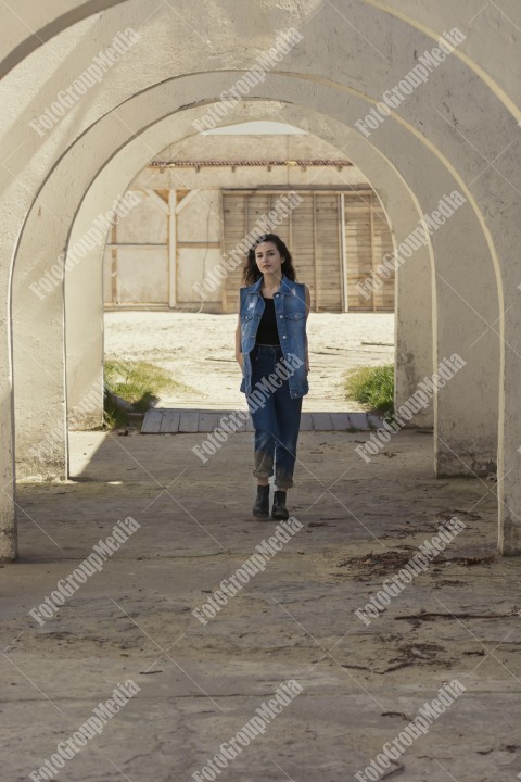 Young woman dressed in denim posing for camera