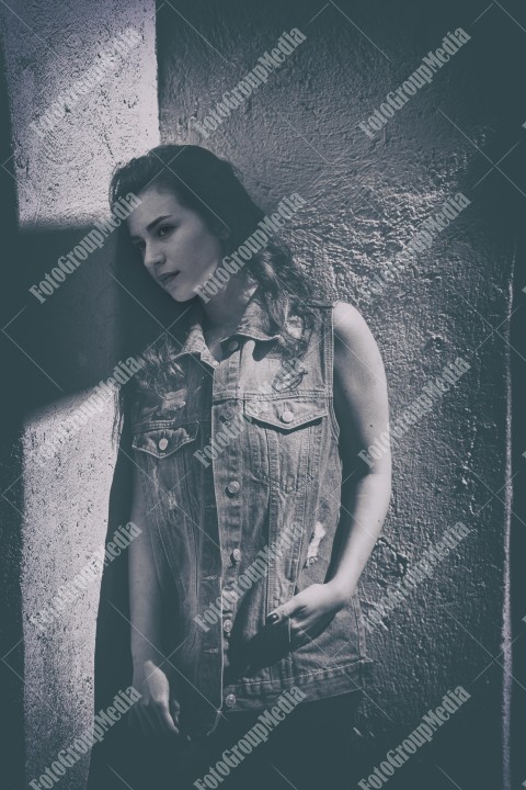 Young woman dressed in denim posing for camera