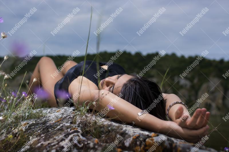 Young girl wearing black bodysuit posing outdoor
