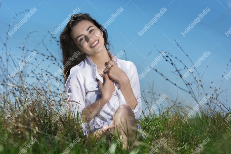 Model posing on a sunny day in a meadow