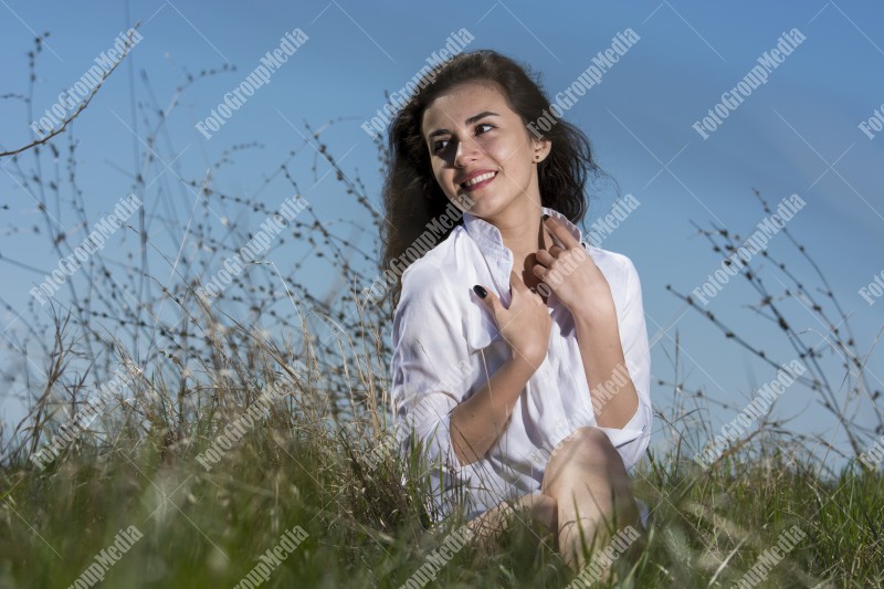 Model posing on a sunny day in a meadow