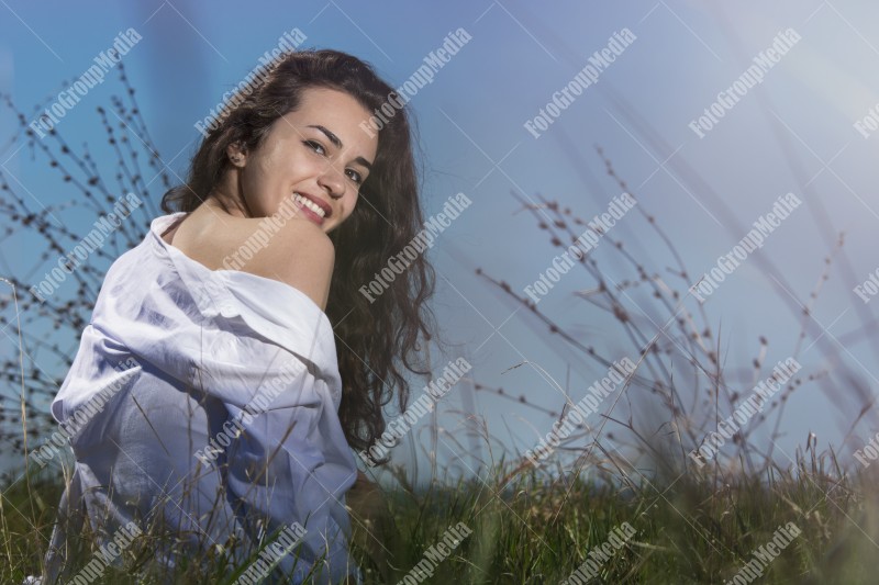 Model posing on a sunny day in a meadow