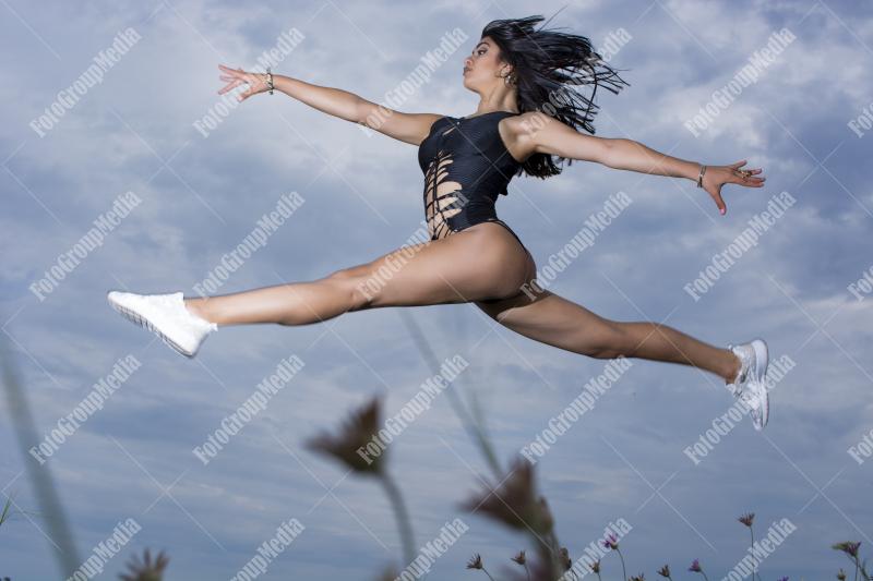 Young girl wearing black bodysuit posing outdoor