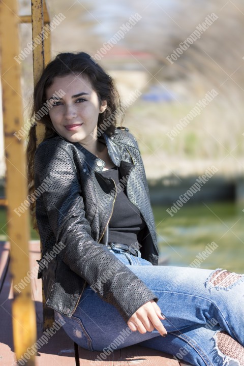Outdoor portrait using lake shore as background