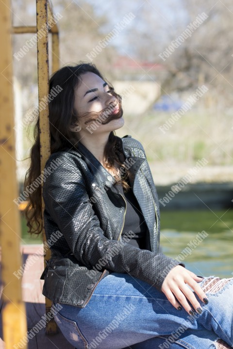 Outdoor portrait using lake shore as background