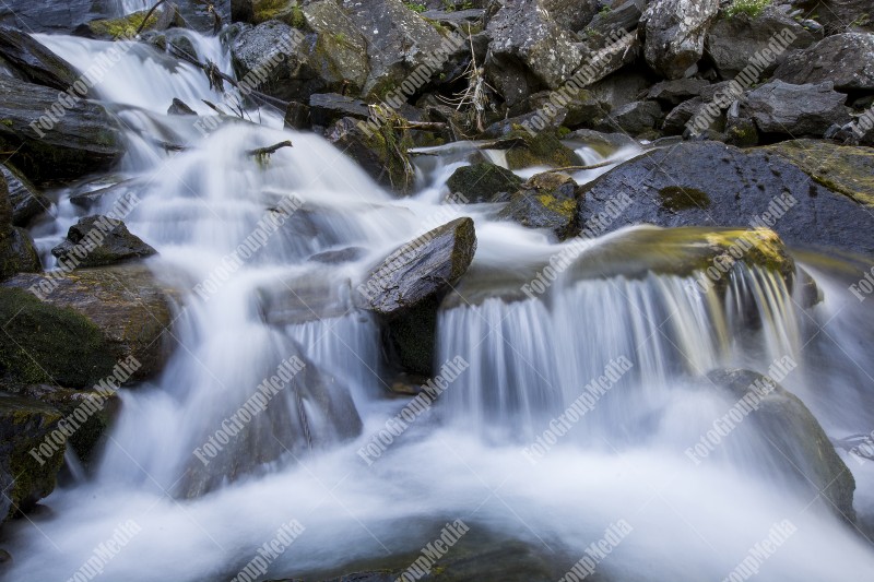 Waterfall on mountain river in Carpathian Mountains, Romania