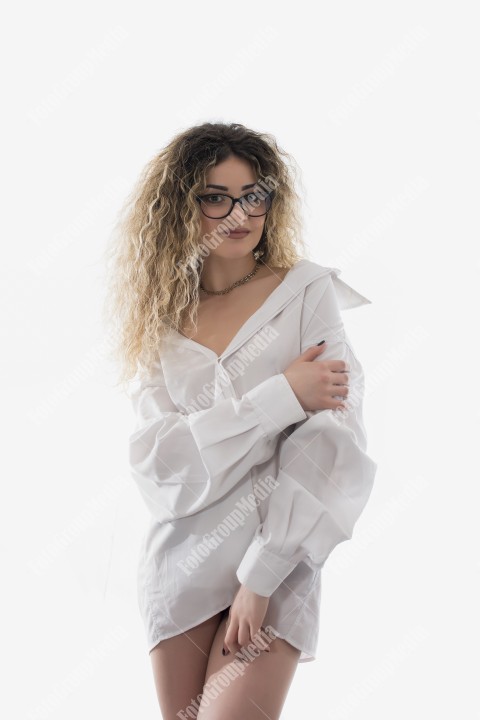Woman with curly hair and white shirt posing on white background