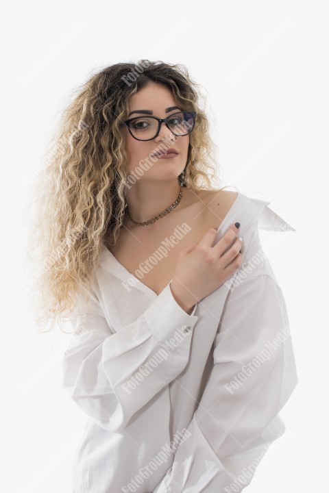 Woman with curly hair and white shirt posing on white background