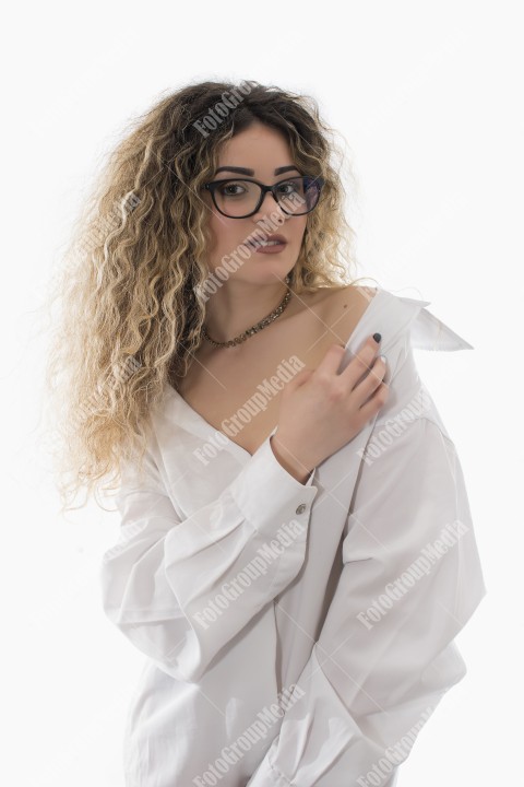 Woman with curly hair and white shirt posing on white background