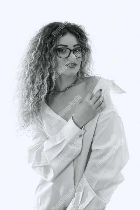 Woman with curly hair and white shirt posing on white background